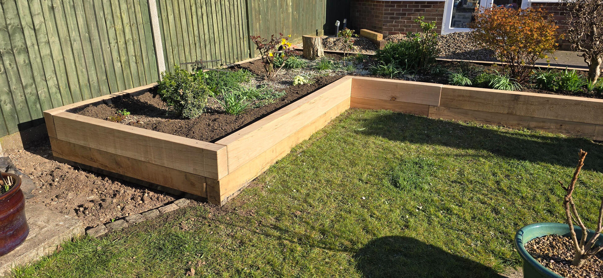 Raised sleeper bed constructed by MJA Garden Landscaping, supplied by Equestrian Fencing in Wickham.